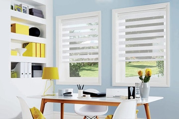 Home office with two windows covered by sheer blinds