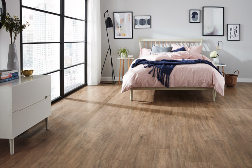 Loose lay vinyl plank flooring installed in a contemporary apartment bedroom