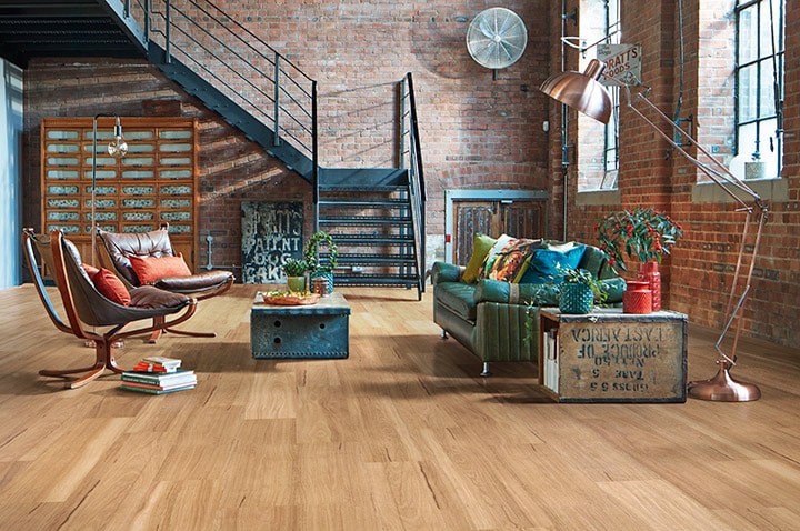 An eclectically designed lounge room in an industrial style loft