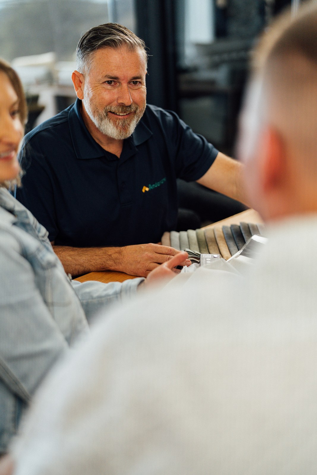 An Andersens consultant talking a customer through a rack of samples