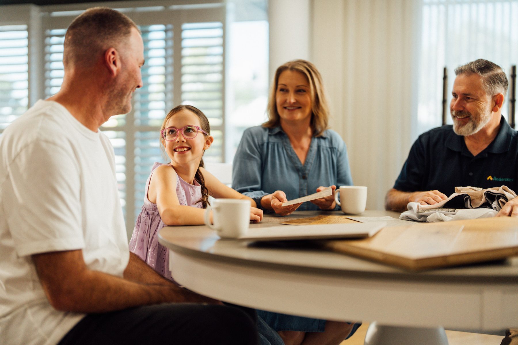 Family reviewing flooring samples at home with Andersens staff