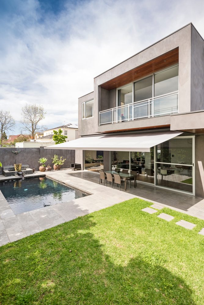 A folding arm awning over an outdoor area