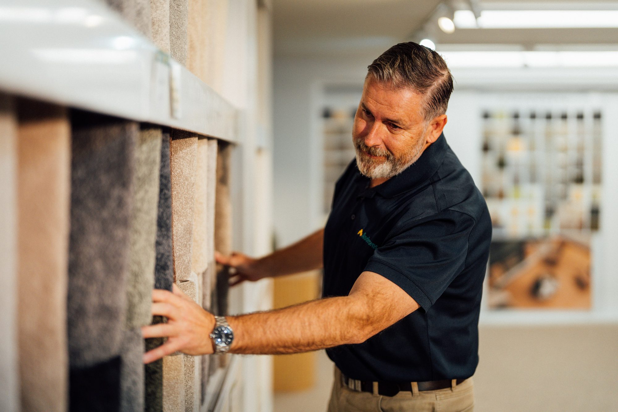 An Andersens team member drawing a carpet sample from the racks in the showroom