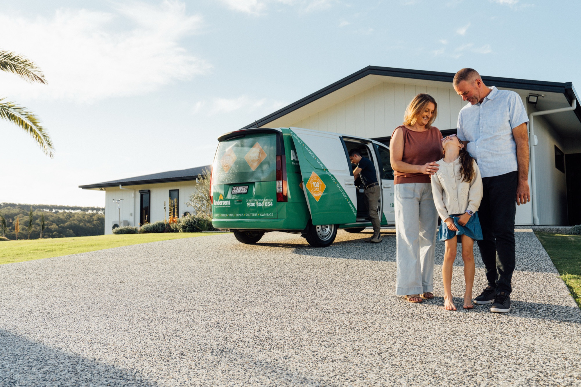 An Andersens vehicle and consultant with a family outside their home