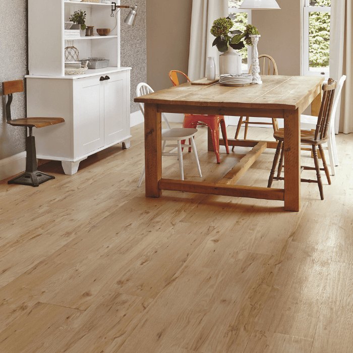 A light oak timber floor in a dining room with a rustic timber table