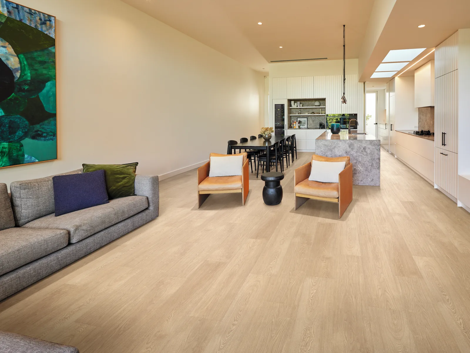 Light timber-look vinyl plank flooring running through an open plan living, dining and kitchen area