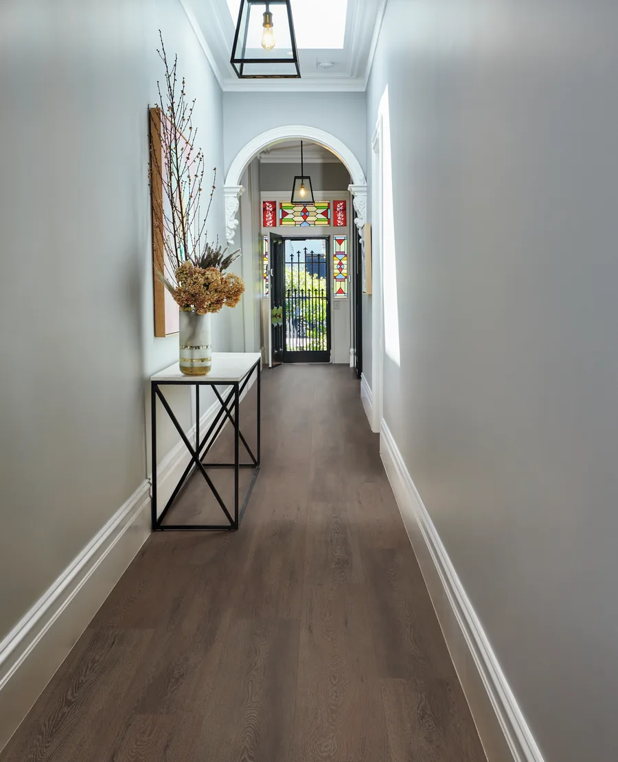 Dark timber-look vinyl plank flooring running the length of a hallway