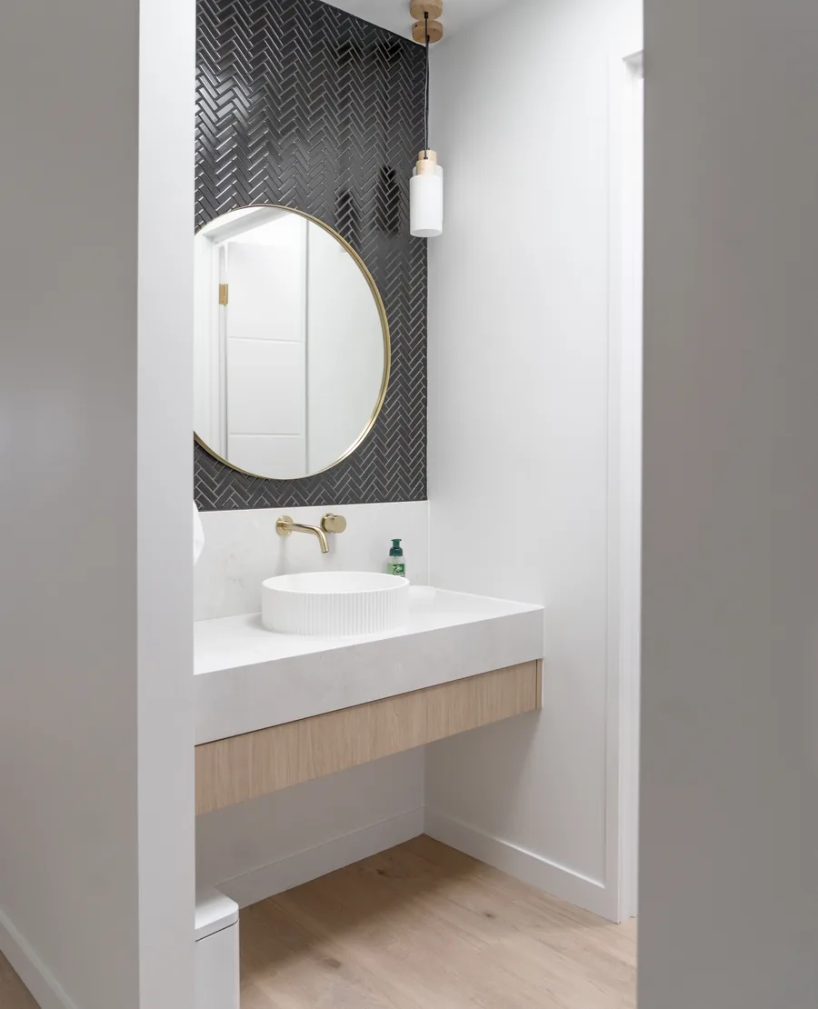 Vinyl plank flooring in a powder room with a wall hung basin