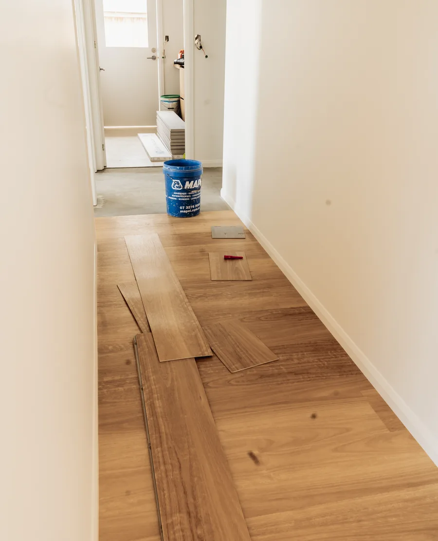 Vinyl planks part way through being laid along a hallway