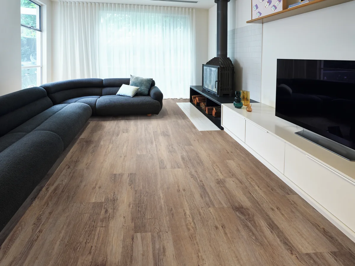 Textured timber-look vinyl planks in a living room with a corner lounge