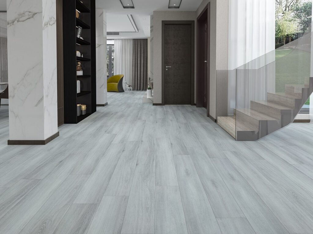 A pale grey timber-look hybrid floor in a hallway beside a staircase